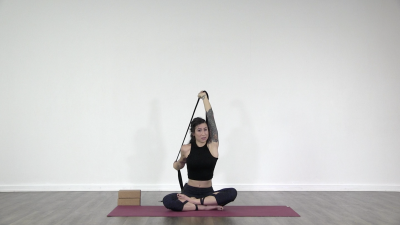 Lauren is practising yoga on a green yoga mat