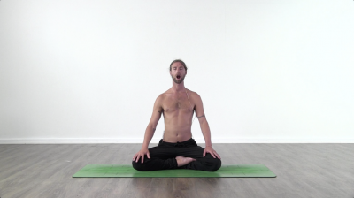 Yoga teacher performing yoga posture on green yoga mat on white background