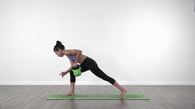 Yoga teacher performing yoga posture on green yoga mat on white background