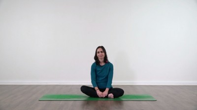 Yoga teacher performing yoga posture on green yoga mat on white background
